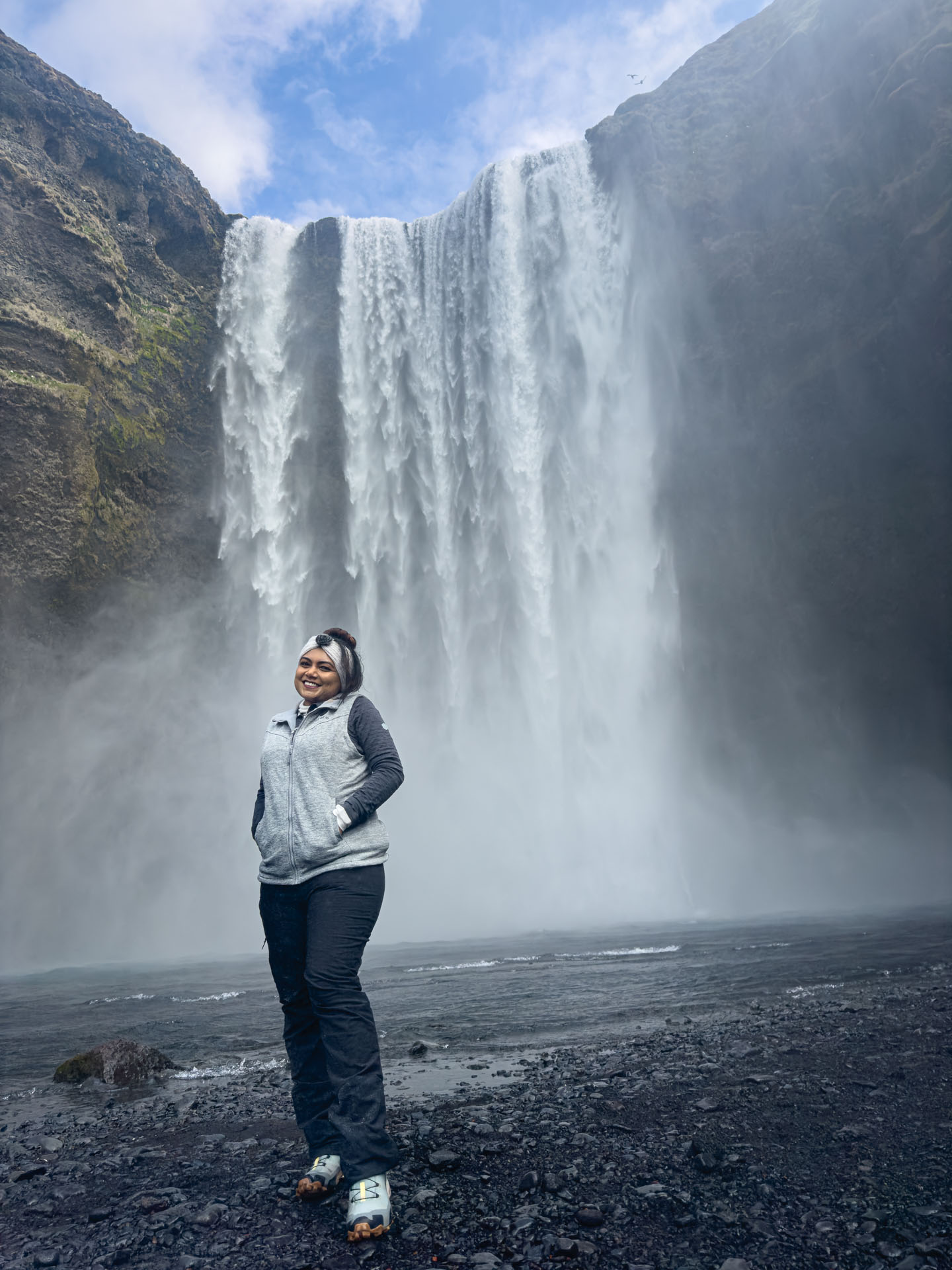 Girl standing in front of Skógafoss Waterfall during Arctic Adventures South Shore Adventure Tour