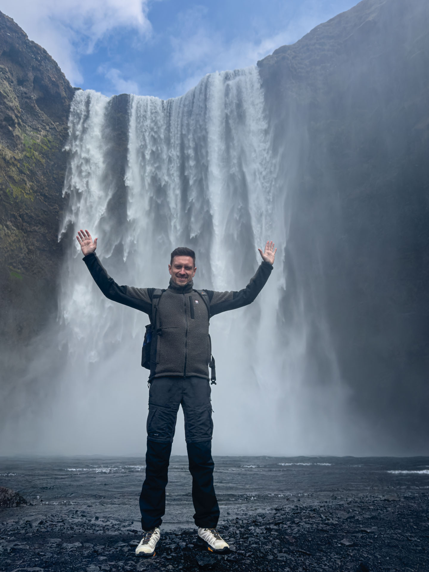 Man standing in front of Skógafoss Waterfall during Arctic Adventures South Shore Adventure Tour