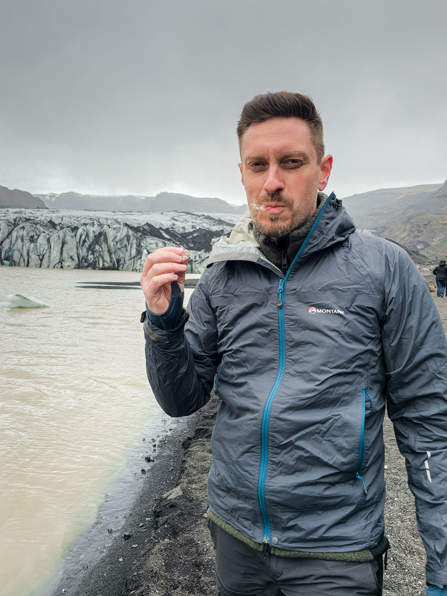 Eating ice from Sólheimajökull Glacier on Arctic Adventures South Shore Adventure Tour