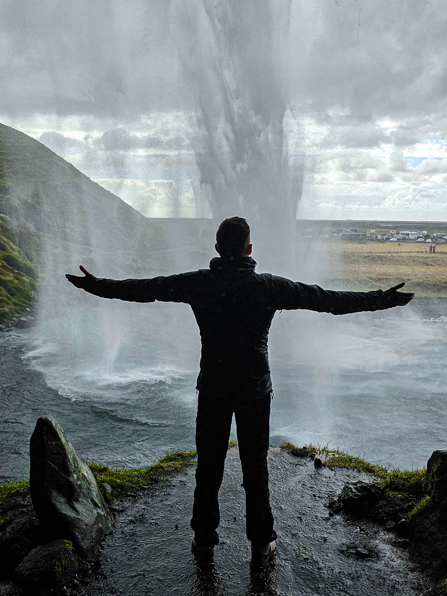 Standing under Seljalandsfoss waterfall on Arctic Adventures South Shore Adventure Tour